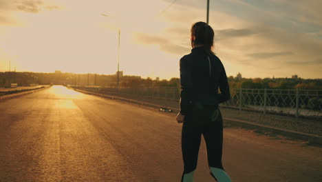 alone-woman-is-running-on-road-in-sunset-time-training-outdoor-keeping-fit-and-healthy-lifestyle